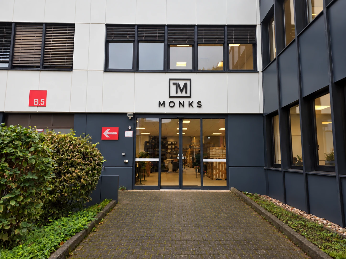 Retouched MONKS entrance with an added logo above the door